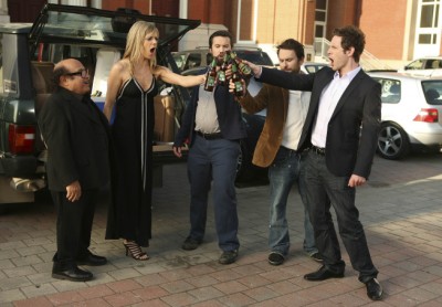 Dee, Mac, Charlie and Dennis prepare to smash their beer bottles as Frank watches