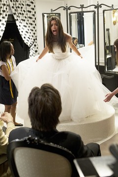 Bridezilla Estefania (Stephanie Fantauzzi) tries on dresses for fake wedding pictures.