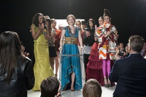 Cathy surprises Andrea by replacing the size 2 model and working the runway herself. It is her 'death' dress after all.