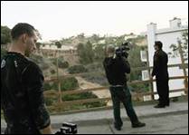 Nick Groff (l.), Aaron Goodwin (c.) and Zak Bagans (r.) explore the area surrounding the Oman House. 