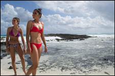 Locals walk along a private hidden beach in Cozumel, Mexico in “Bikinis & Boardwalks”;