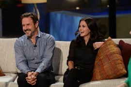 Executive Producers and guest celebrities Courtney Cox and David Arquette having fun on the couch.