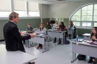 Keith initially dismisses his class for a month at the beginning of the semester, but he's forced to change his lesson plans or lose his job.