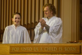 Father Tim applauds Paige's accomplishments. I've never seen her so happy.