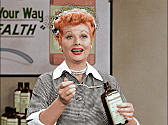 Lucy Ricardo (Lucille Ball) takes a sip of "Vitameatavegamin" from Lucy Does a TV Commercial, one of the newly colorized episodes featured in the I LOVE LUCY CHRISTMAS SPECIAL, a new one-hour special featuring two back-to-back colorized classic episodes of the series, to be broadcast Wednesday, Dec. 23 (8:00-9:00 PM, ET/PT) on the CBS Television Network.